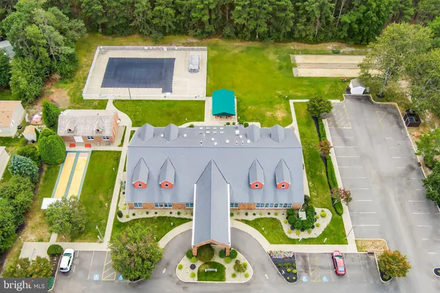a front view of a house with a yard and outdoor seating