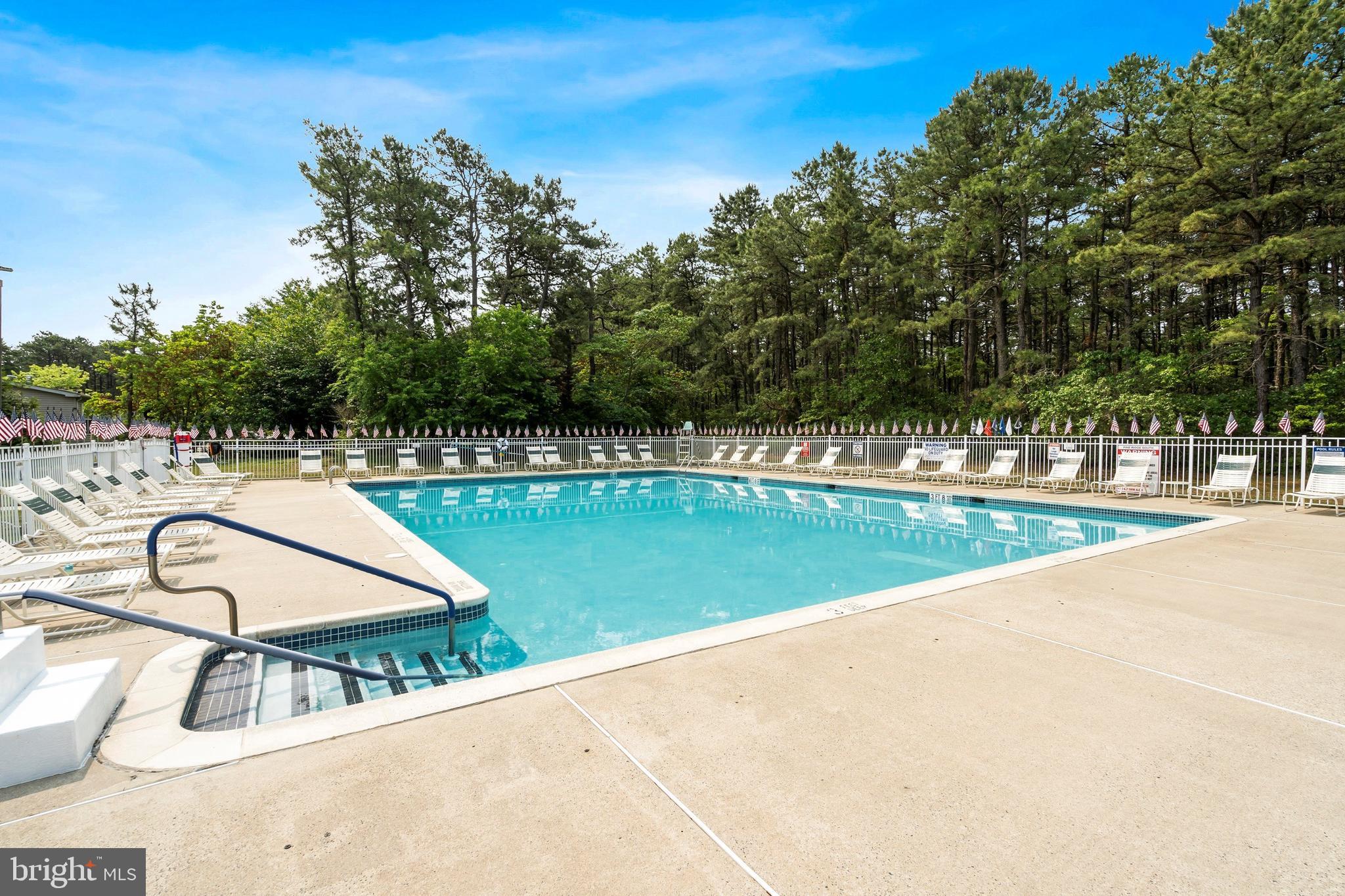 1104 Sycamore Court Whiting, NJ 08759 - Photo 45 of 54 a swimming pool with trees in the background