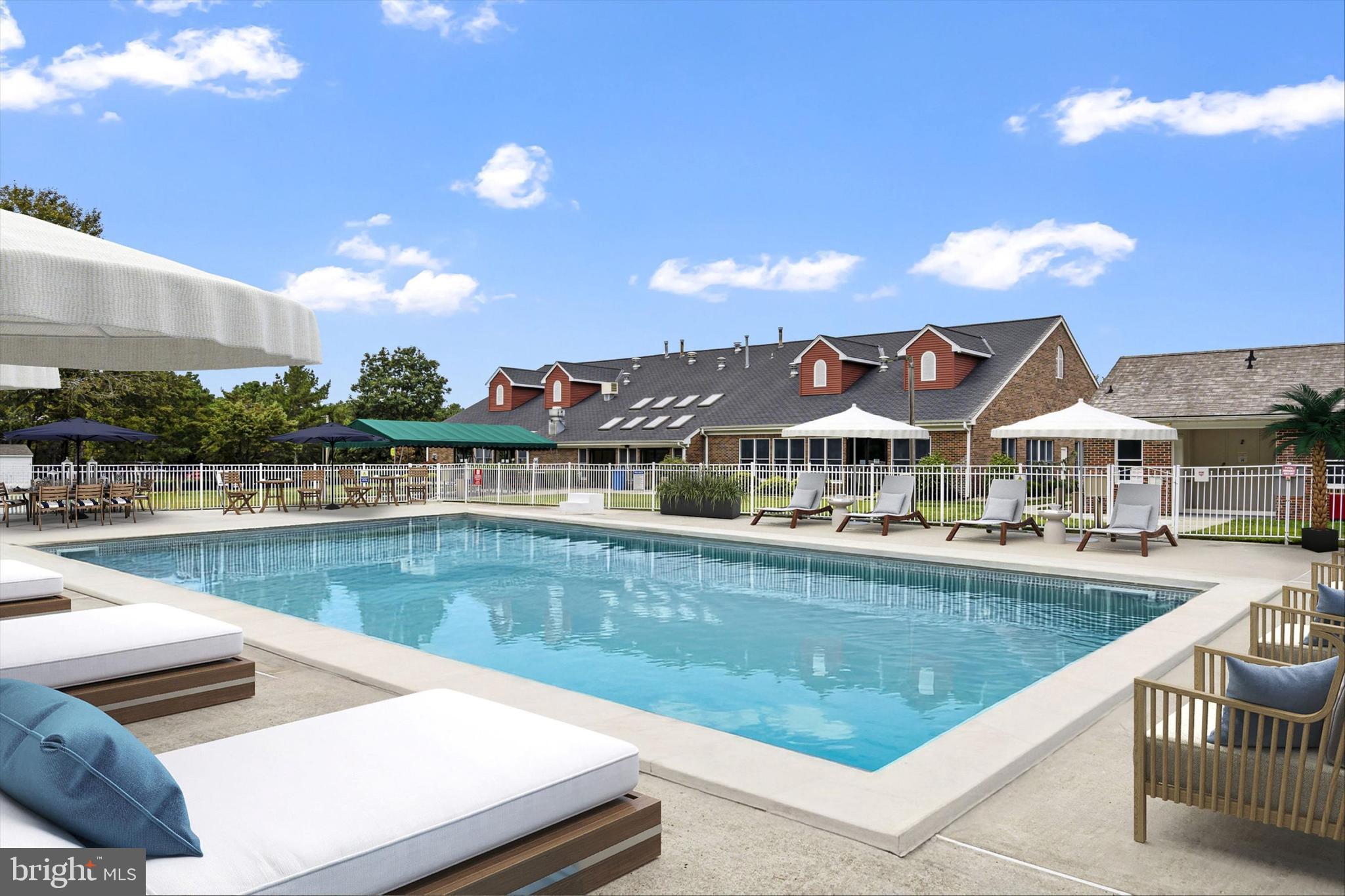 1104 Sycamore Court Whiting, NJ 08759 - Photo 47 of 54 a view of a swimming pool with lawn chairs and a dining table under an umbrella