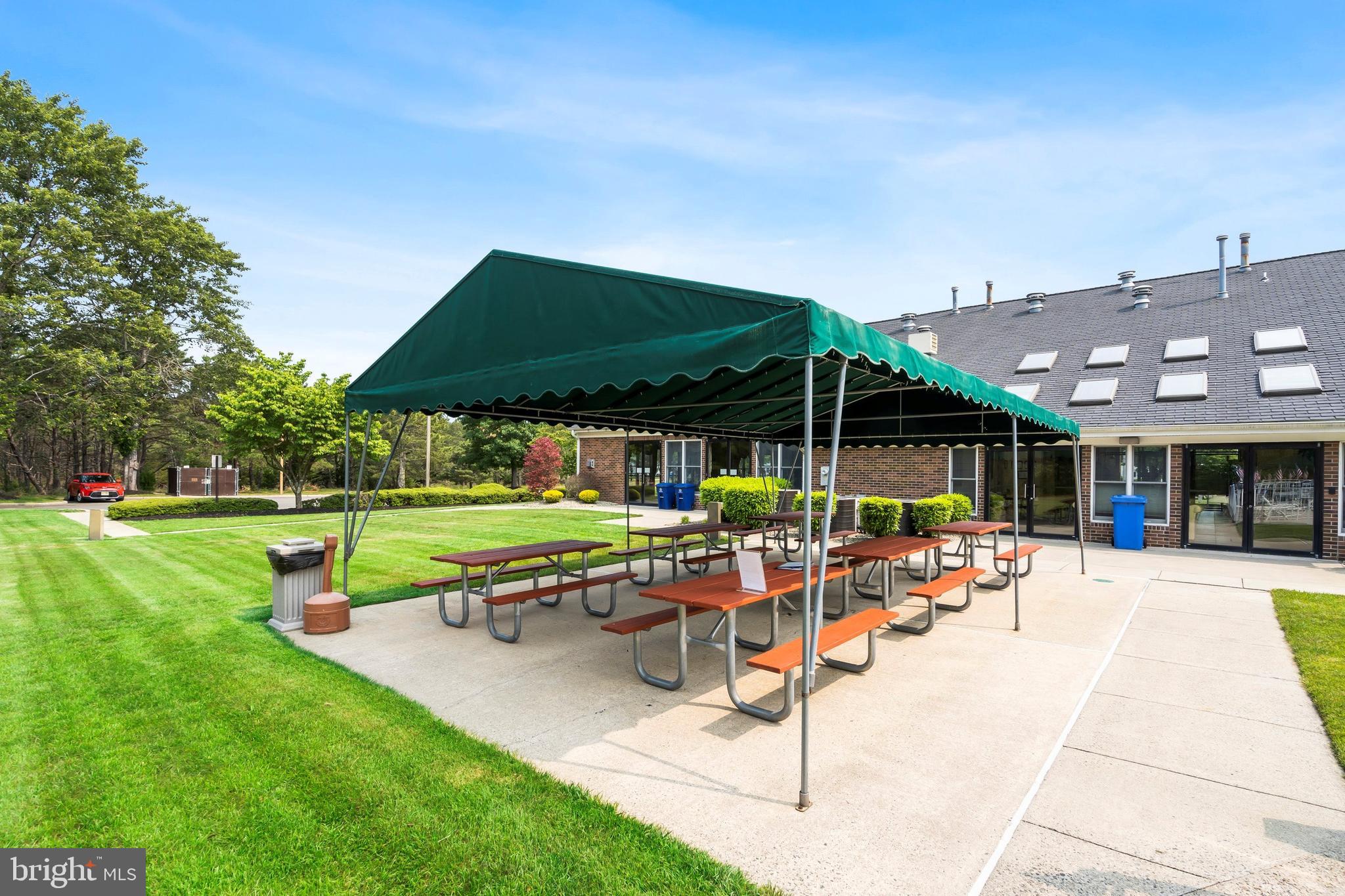 1104 Sycamore Court Whiting, NJ 08759 - Photo 49 of 54 a patio with a table and chairs under an umbrella
