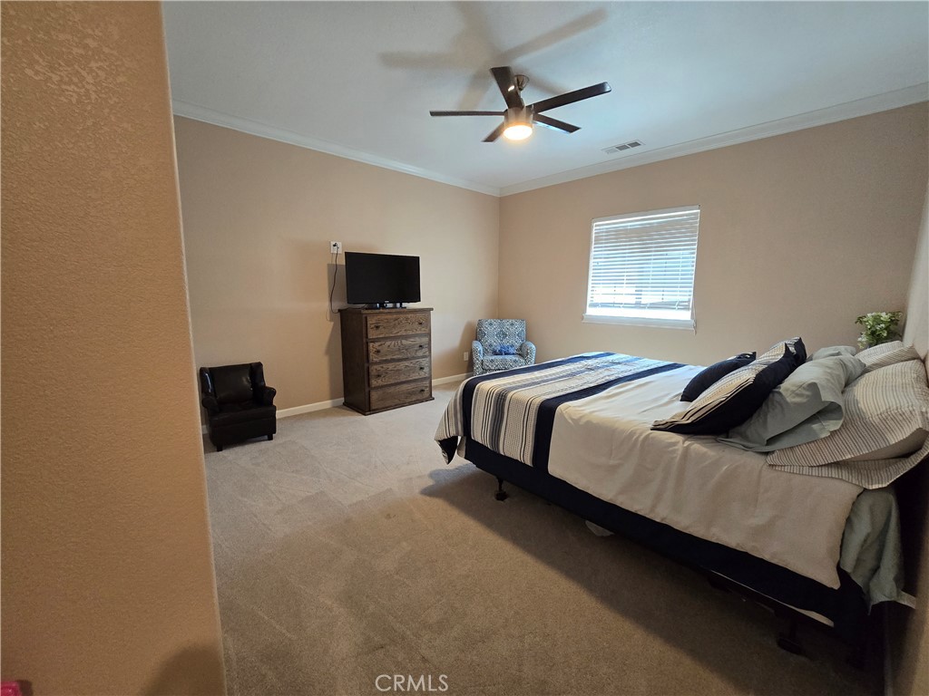 5995 West Brooks Road Merced, CA 95341 - Photo 11 of 20 a bedroom with a bed and a flat screen tv