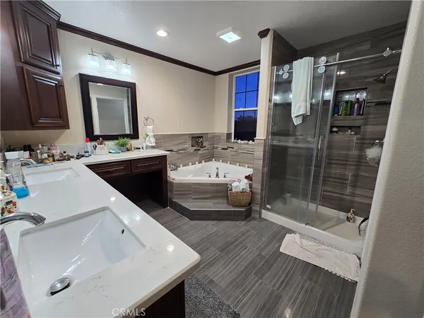 a bathroom with a toilet a sink a mirror a vanity and shower