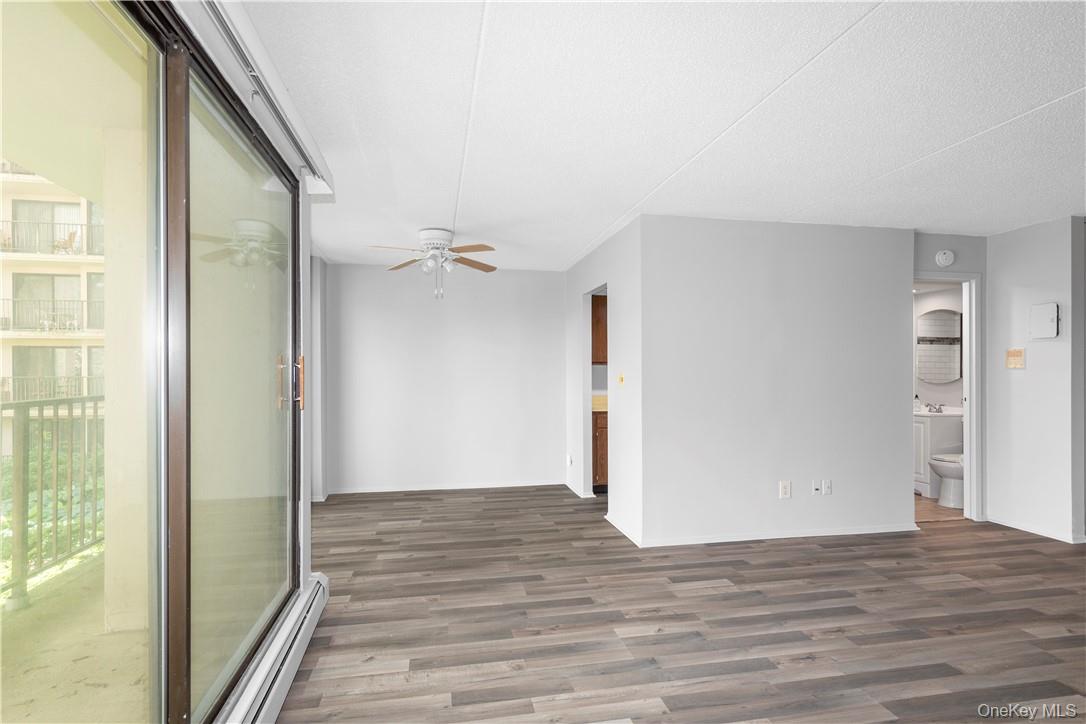 150 Overlook Avenue, Unit 2K Peekskill, NY 10566 - Photo 5 of 26 a view of an empty room with wooden floor and a window