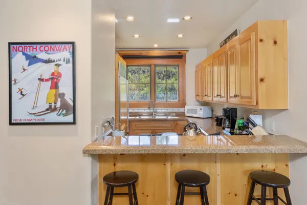 a dining room with furniture a chandelier and wooden floor