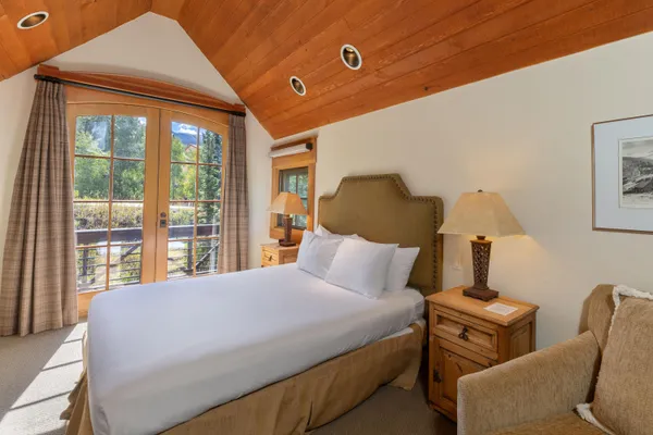 a bathroom with a tub a sink and a window