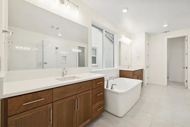 a bathroom with a sink a toilet a mirror and bathtub