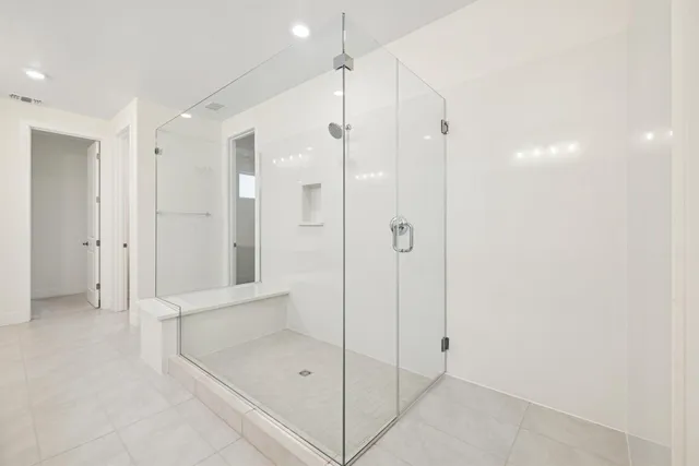 a bathroom with a shower and a sink