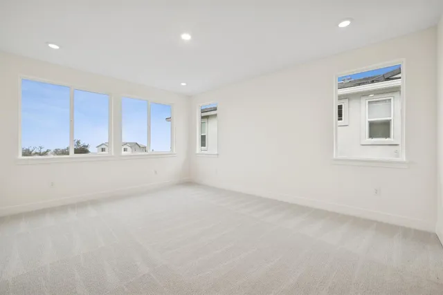 a view of an empty room with a kitchen