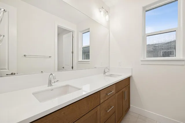 a bathroom with a sink double vanity and a mirror