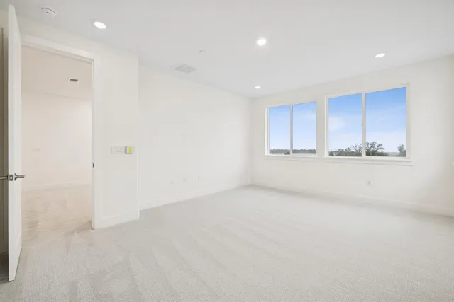 a view of an empty room with a kitchen