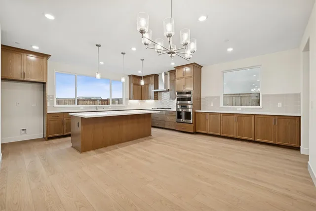 a large kitchen with stainless steel appliances kitchen island granite countertop a large counter top and stainless steel appliances