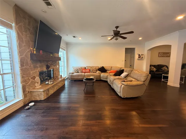 a living room with fireplace furniture and a wooden floor