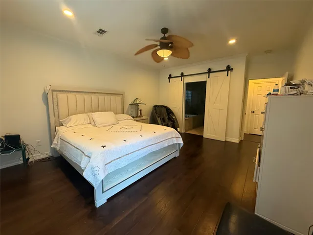 a bed sitting in a spacious bedroom next to a window