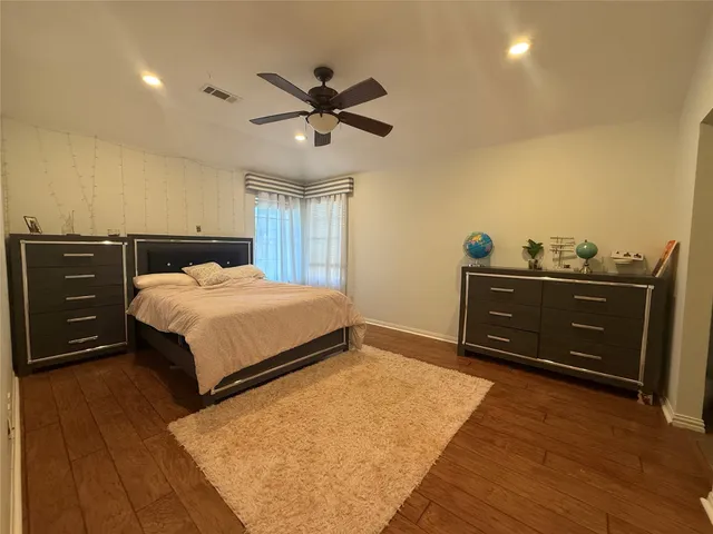 a bedroom with a bed and ceiling fan