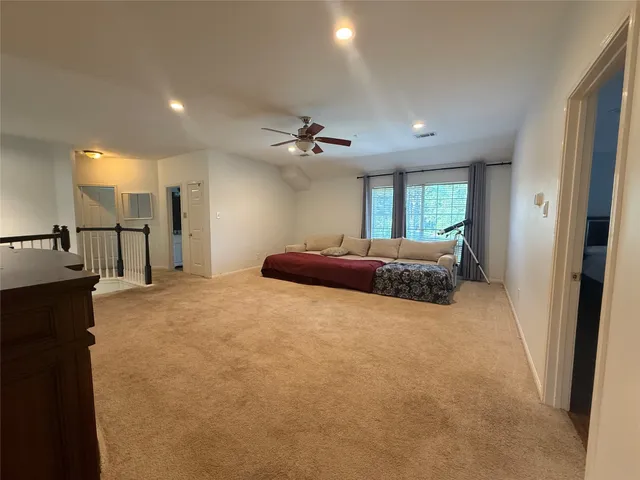 a large bedroom with a bed and a chandelier