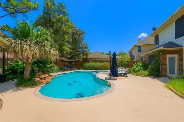 a view of a swimming pool with a patio