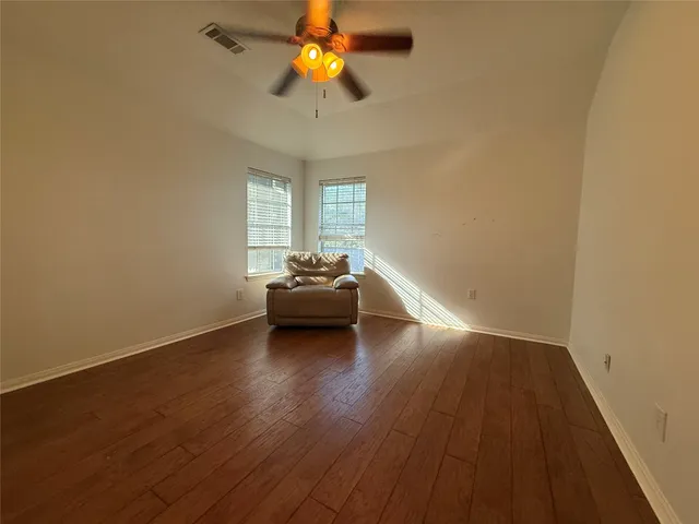 a living room with furniture and a ceiling fan