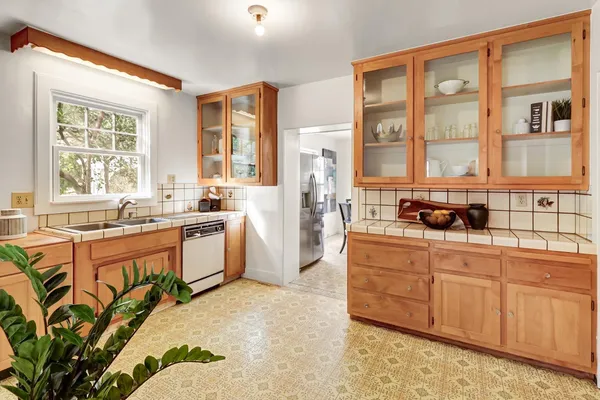 a kitchen with stainless steel appliances granite countertop a refrigerator and a stove