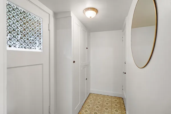a bathroom with a tub sink and mirror