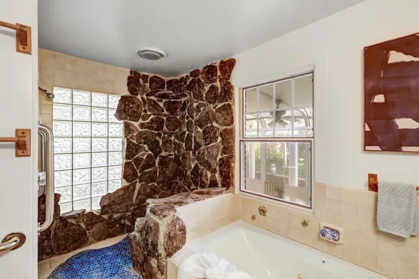 a bedroom with a large bed and wooden floor