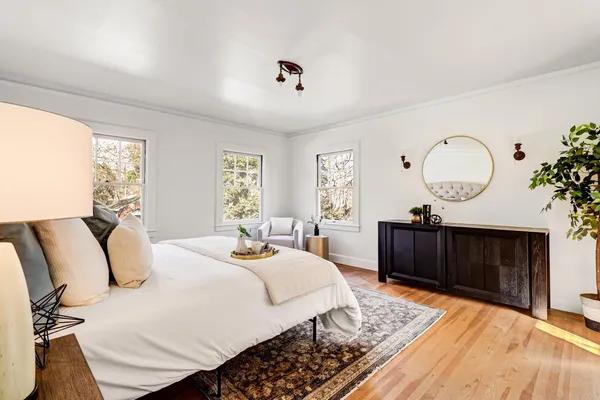 a bedroom with a bed and a potted plant