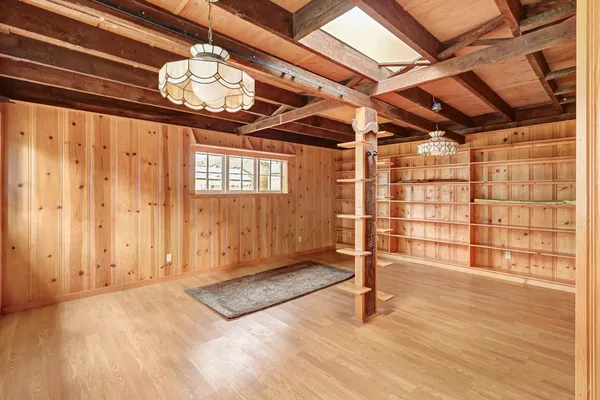 a backyard of a house with table and chairs and potted plants