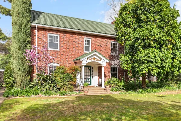 a view of a patio with table and chairs and potted plants