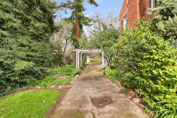a front view of a house with a garden and plants