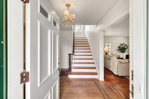 a living room with furniture a fireplace and a large window