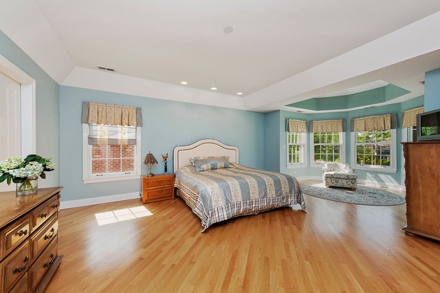 330 Greenleaf Avenue Wilmette, IL 60091 - Photo 13 of 23 a bedroom with a bed and wooden floor