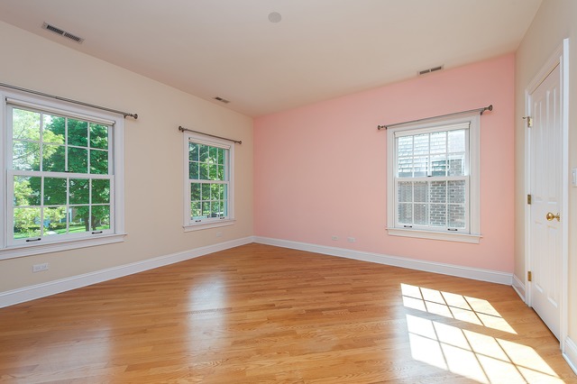 330 Greenleaf Avenue Wilmette, IL 60091 - Photo 18 of 23 a view of an empty room with wooden floor and a window