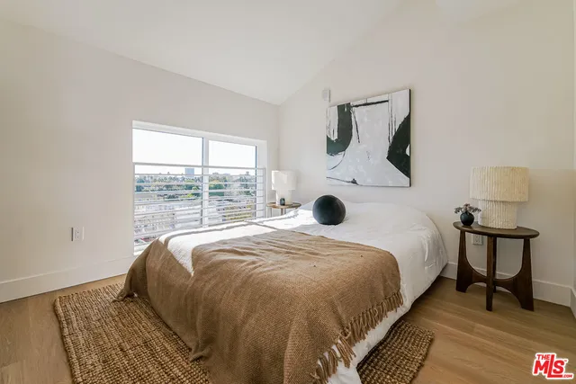 a bed sitting in a bedroom next to a window