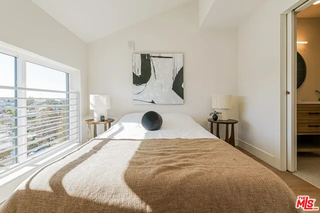 a bedroom with a large bed and a large window