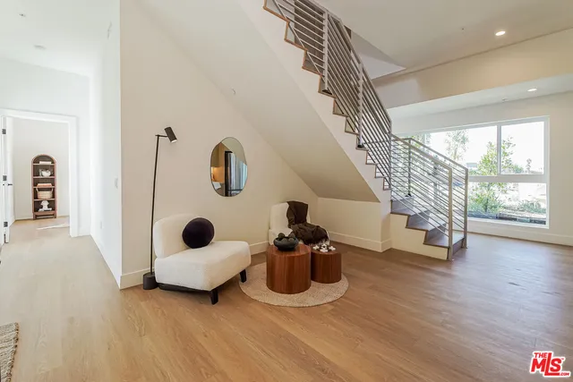 a view of entryway and hall with wooden floor