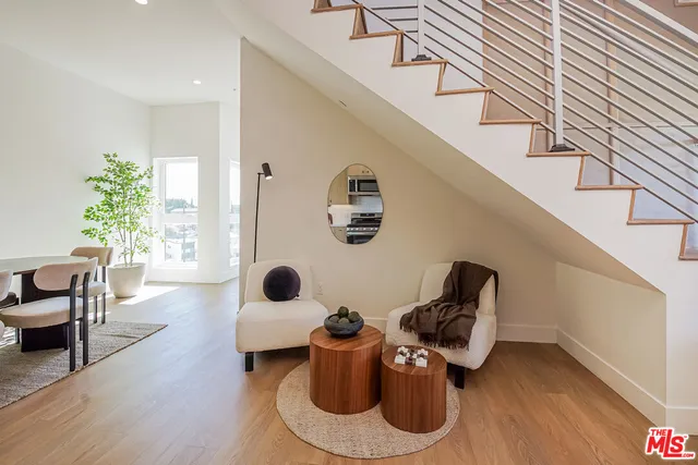 a floor to ceiling window and wooden floor