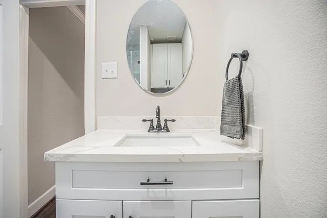 a bathroom with a sink and a mirror