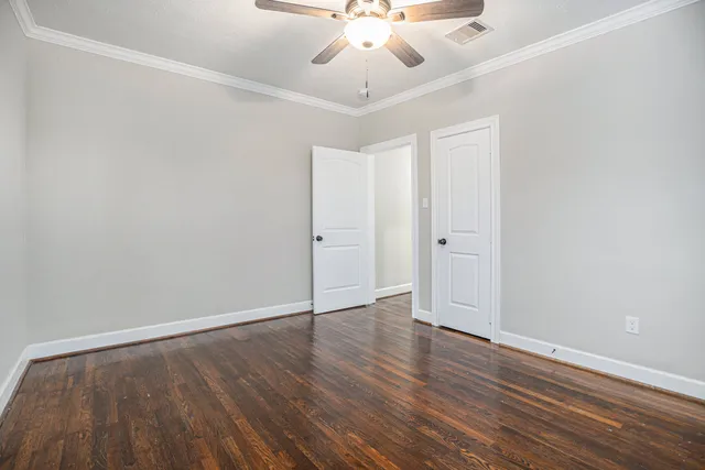 a view of an empty room with wooden floor