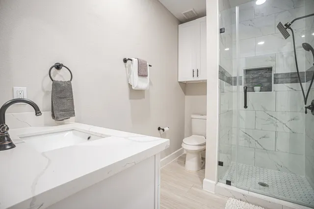 a bathroom with a toilet sink and shower