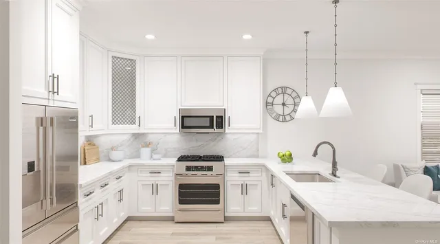 a kitchen with stainless steel appliances granite countertop a stove a sink and a refrigerator