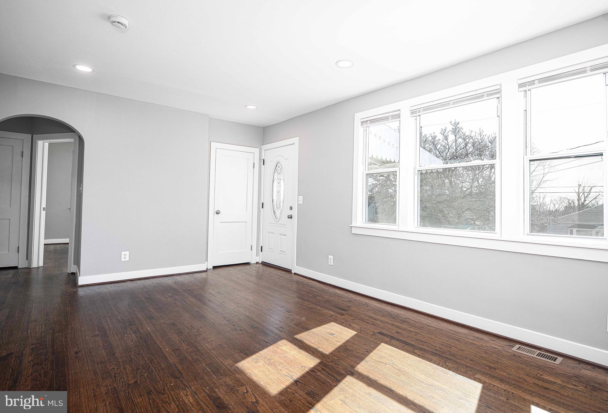 7906 31st Street Rosedale, MD 21237 - Photo 11 of 33 a view of an empty room with wooden floor and a window