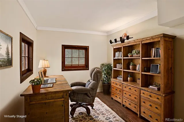 a backyard of a house with large trees and wooden fence