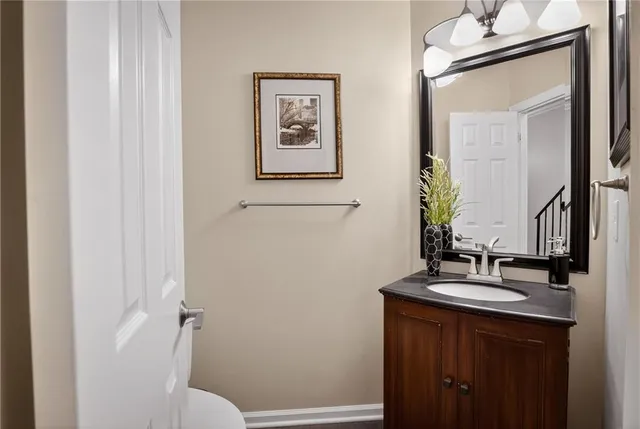 a bathroom with a sink and a mirror with toilet
