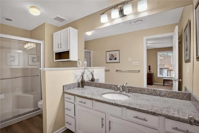 a bathroom with a granite countertop sink and a mirror