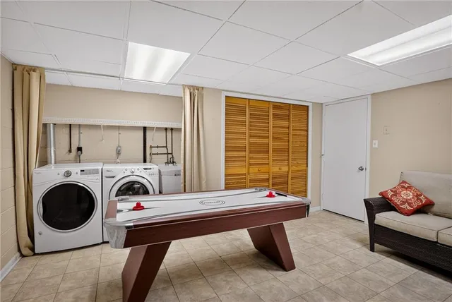 a living room with furniture pool table and flat screen tv