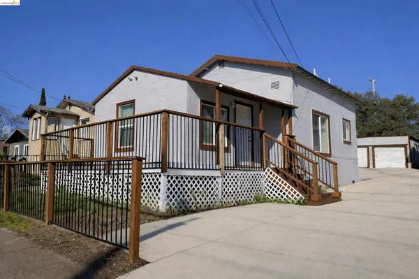 a view of a house with a wooden fence
