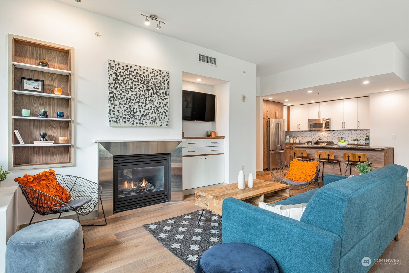 910 Lenora Street, Unit S310 Seattle, WA 98121 - Photo 11 of 40 a living room with furniture a flat screen tv and a fireplace