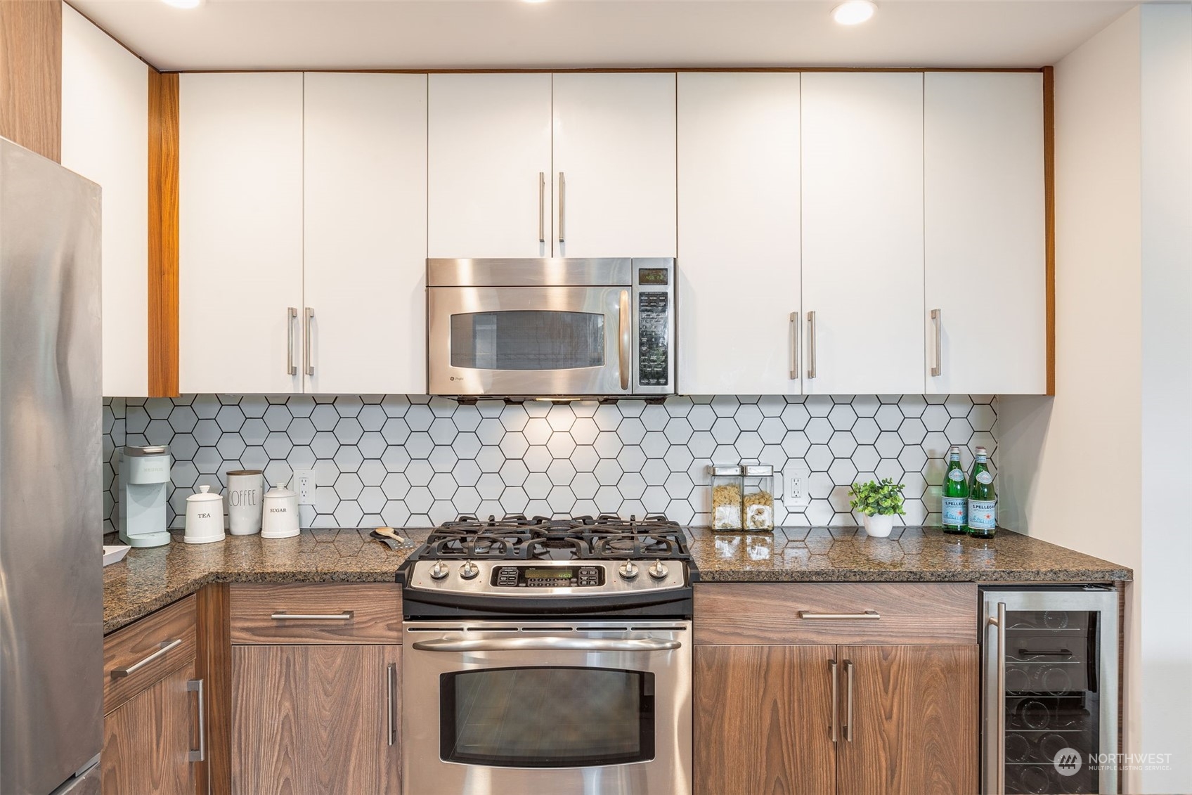 910 Lenora Street, Unit S310 Seattle, WA 98121 - Photo 18 of 40 a kitchen with stainless steel appliances white cabinets and a stove top oven