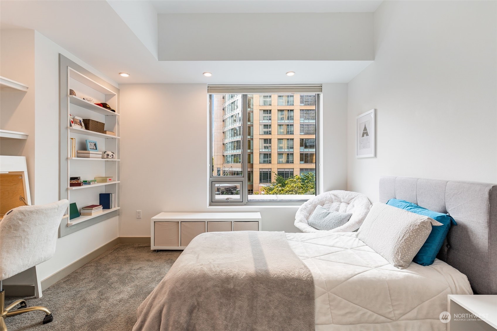 910 Lenora Street, Unit S310 Seattle, WA 98121 - Photo 19 of 40 a spacious bedroom with a bed a table and a large window