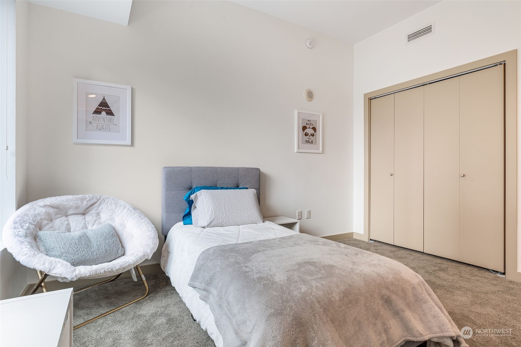 910 Lenora Street, Unit S310 Seattle, WA 98121 - Photo 20 of 40 a bedroom with a bed and a chair