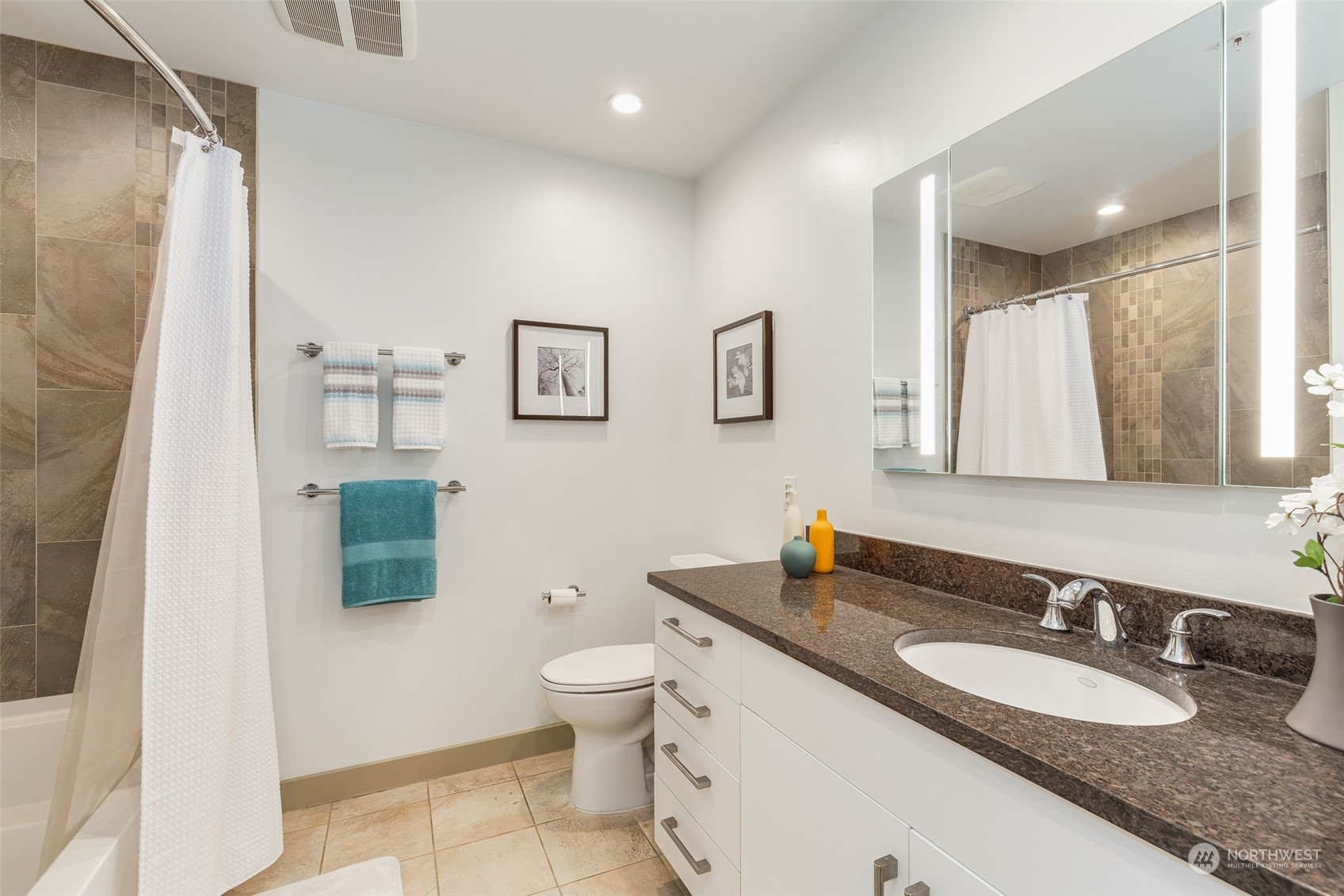 910 Lenora Street, Unit S310 Seattle, WA 98121 - Photo 21 of 40 a bathroom with a granite countertop sink mirror vanity and toilet